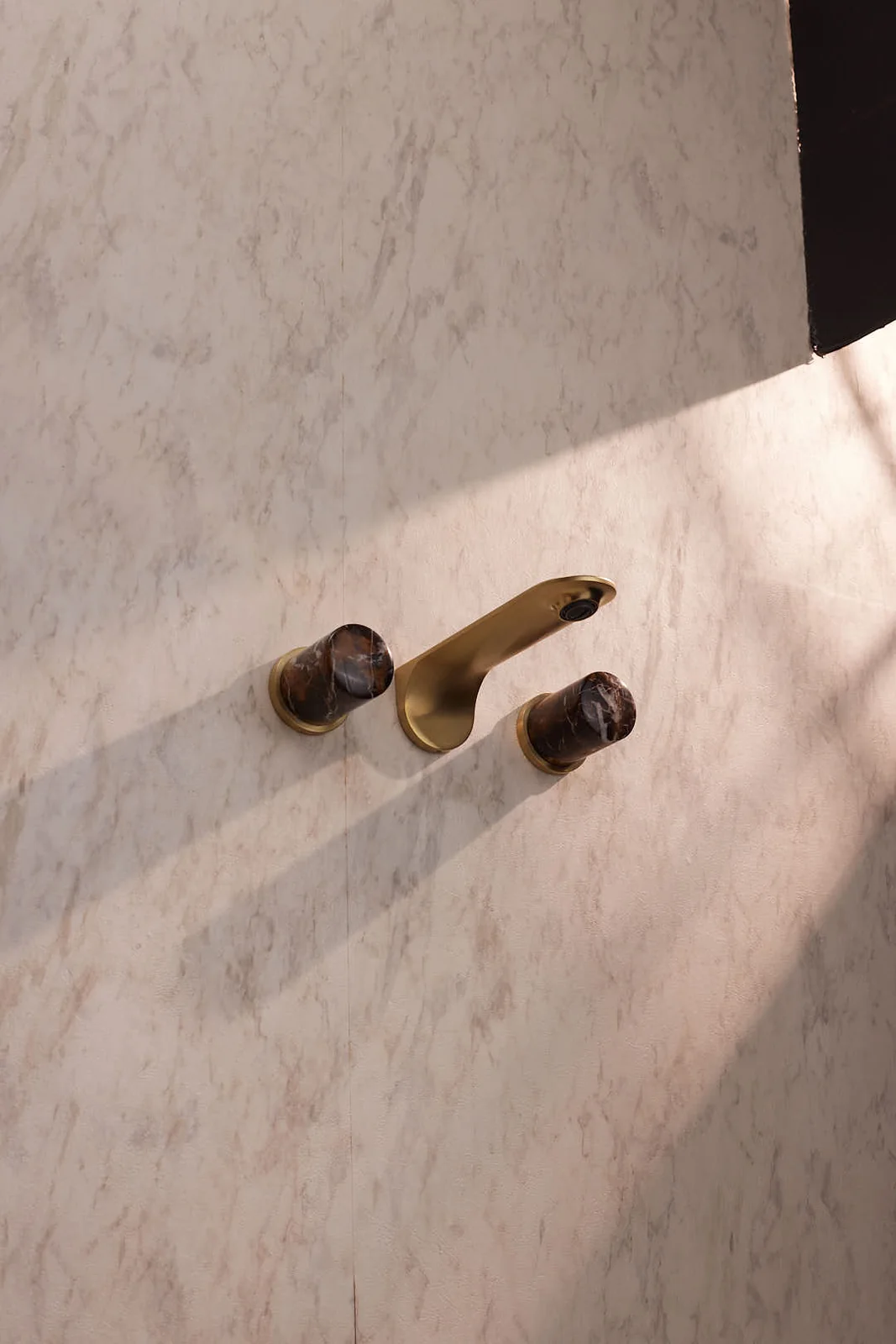 Brass basin mixer and marble counter with a plant